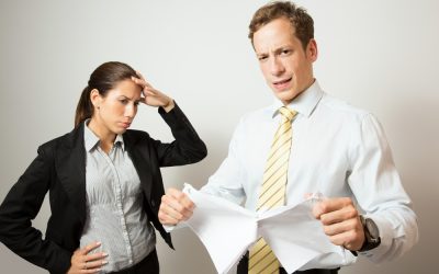 one person giving feedback to another, who looks stressed