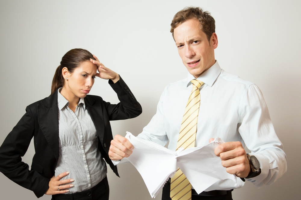 one person giving feedback to another, who looks stressed