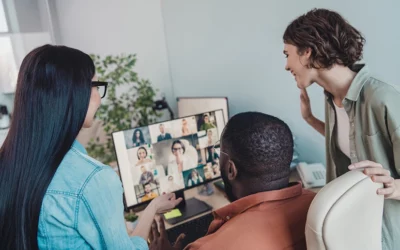 Three teammates together talking with multiple teammates on a video call