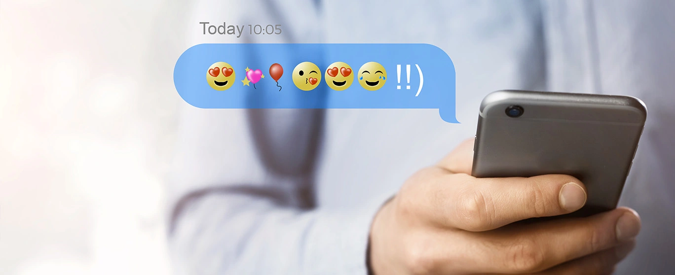 Person texting emojis