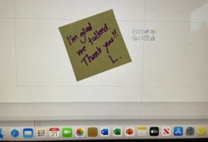 Post-it note stuck to a computer monitor that say, "I'm glad we talked. Thank you!" L