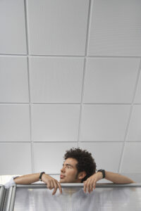 Person looking over a cubicle to ask a question on a hybrid team